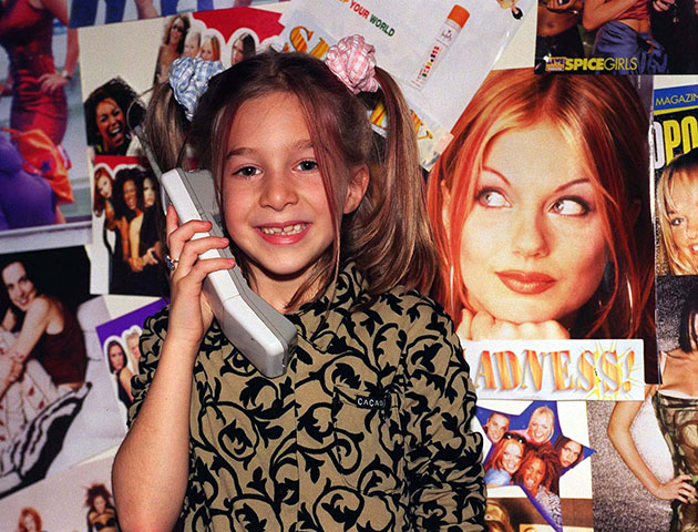 Surrounded by posters of her favourite all girl band, Lily Stodel, uses the phone on which she had a conversation with her Spice Girl heroine, Emma Bunton last night (Saturday). "Baby Spice" rang the 7-year-old from Stanmore in north west London out of the blue after the youngster won a competition to speak to her favourite Spice girl in a school auction. During the 10 minute conversation, she told Lily that the girls had all been very upset about recent bad press following the sacking of their manager and said that they were not going to split up because they were very happy together'. See PA story SHOWBIZ Spice. Photo by Samantha Pearce/PA